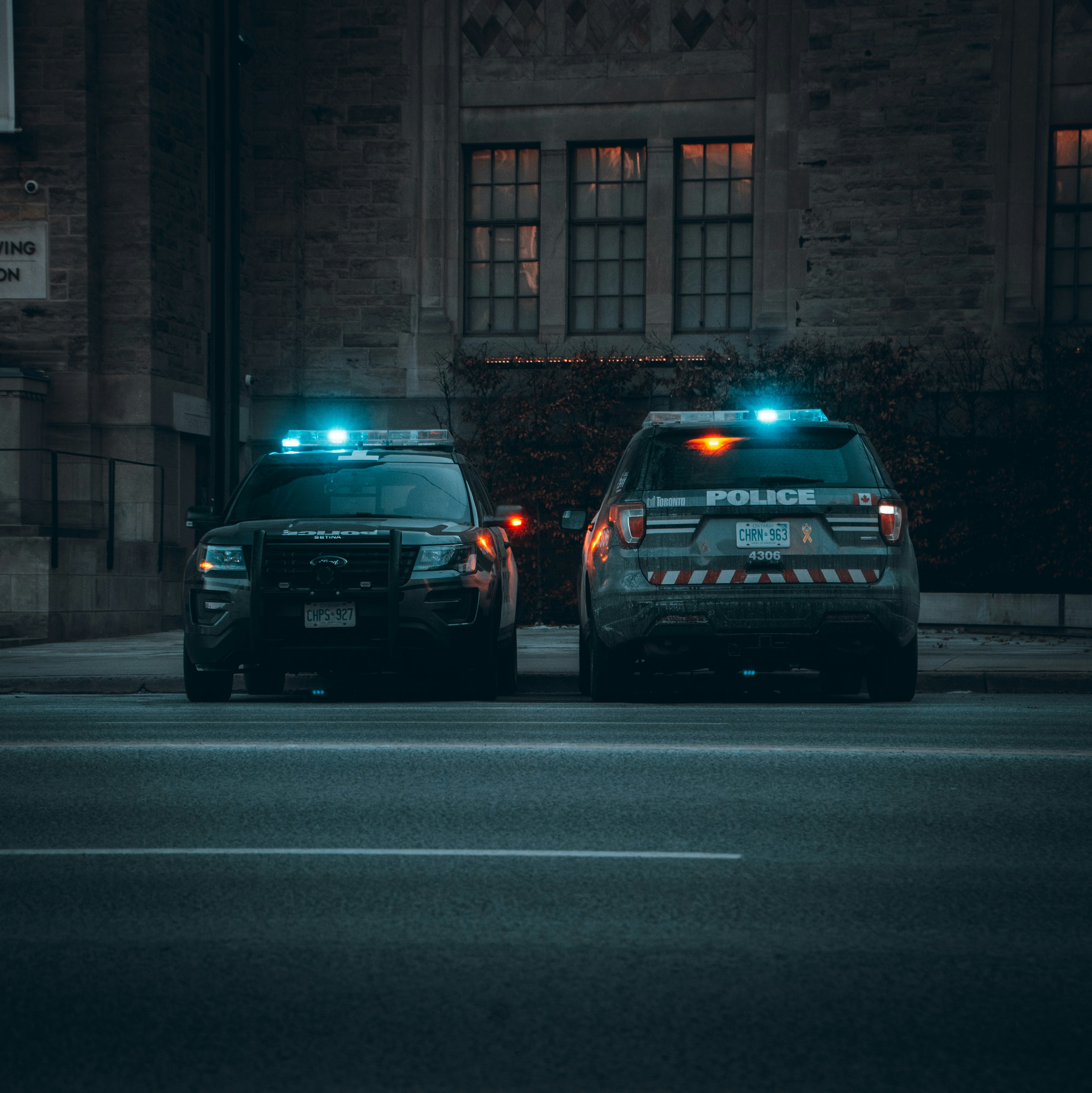 Police fleet SUVs with lights at night